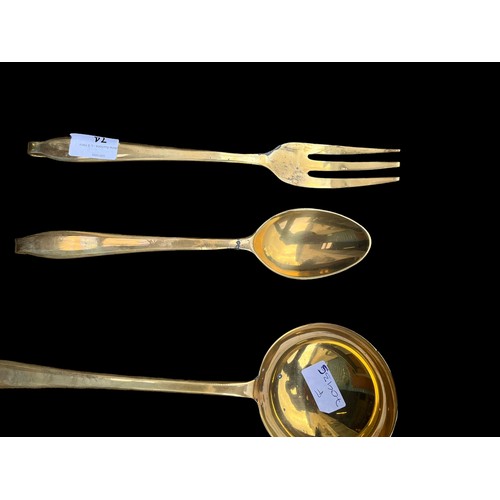 74 - A BRASS OVER COPPER 6 PIECE HANGING UTENILS SET WITH RACK