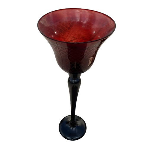 104 - A BRONZE FINISH CANDLE STAND WITH RED GLASS HOLDER 30