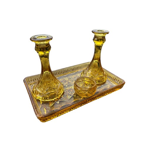 114 - AN AMBER GLASS DRESSING TABLE SET