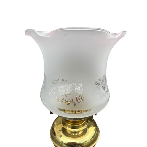 187 - A TABLE LAMP IN FORM OF A  BRASS OIL LAMP WITH SHADE