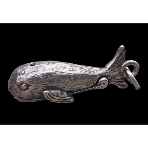 211 - AN ARTICULATED SILVER JONA & THE WHALE PENDANT/CHARM