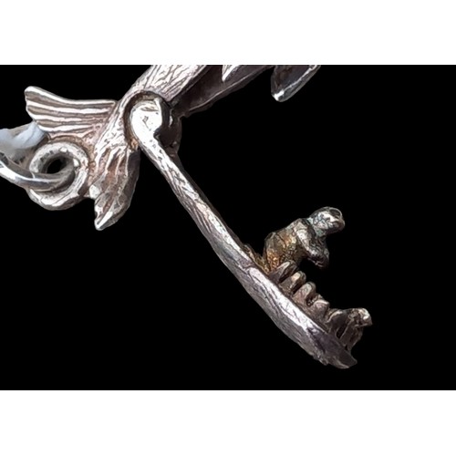 211 - AN ARTICULATED SILVER JONA & THE WHALE PENDANT/CHARM