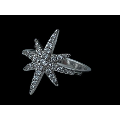 229 - A SILVER GEM SET STAR RING