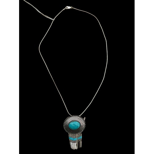 258 - A SILVER AND TURQUOISE PENDANT ON SILVER CHAIN