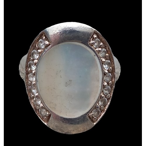 270 - A SILVER AND MOTHER OF PEARL RING WITH GEM STONE SIDES