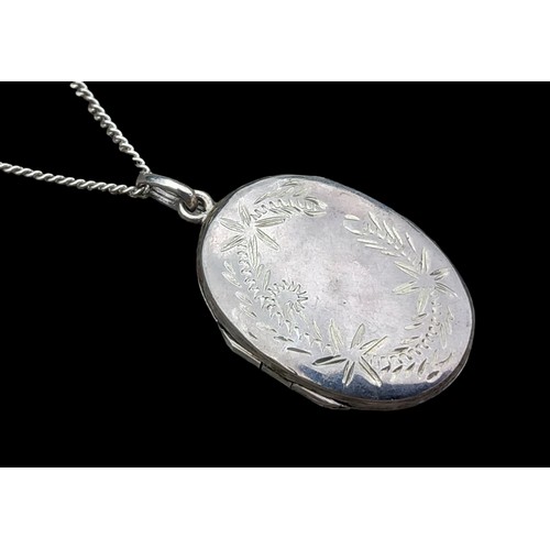 272 - AN ORNATE SILVER LOCKET ON A SILVER CHAIN