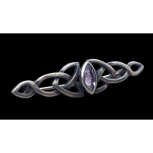 285 - A SILVER CLETIC BROOCH SET WITH AMETHYST STONE