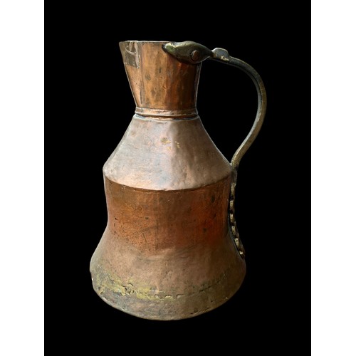 314 - AN ANTIQUE COPPER AND BRASS JUG 10