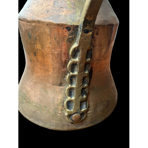 314 - AN ANTIQUE COPPER AND BRASS JUG 10