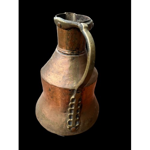 314 - AN ANTIQUE COPPER AND BRASS JUG 10