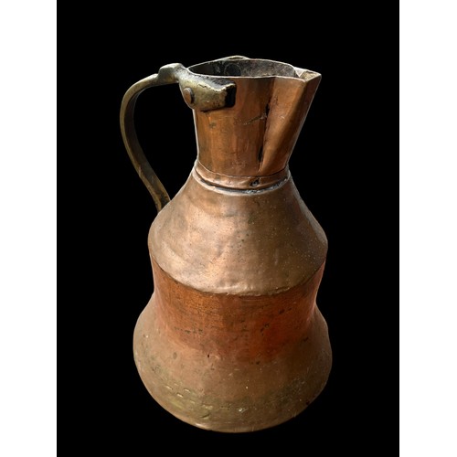 314 - AN ANTIQUE COPPER AND BRASS JUG 10