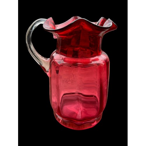 333 - 2 VERY NICELY SHAPED RUBY GLASS JUGS WITH CLEAR GLASS HANDLES