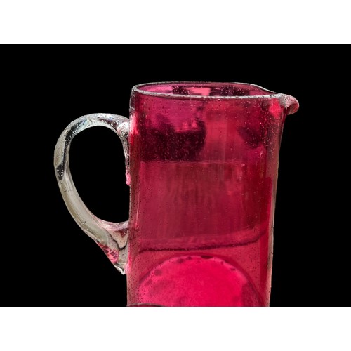 333 - 2 VERY NICELY SHAPED RUBY GLASS JUGS WITH CLEAR GLASS HANDLES