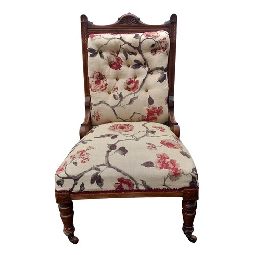 394 - A CARVED ANTIQUE BUTTONED BACK FIRESIDE CHAIR