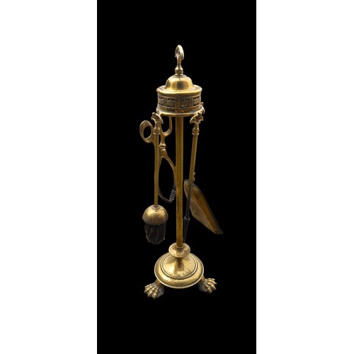 404 - A HEAVY BRASS COMPANION SET ON TRIPOD PAW