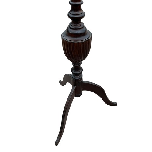 412 - A TALL MAHOGANY TORCJERE ON ORNATE REEDED BASE