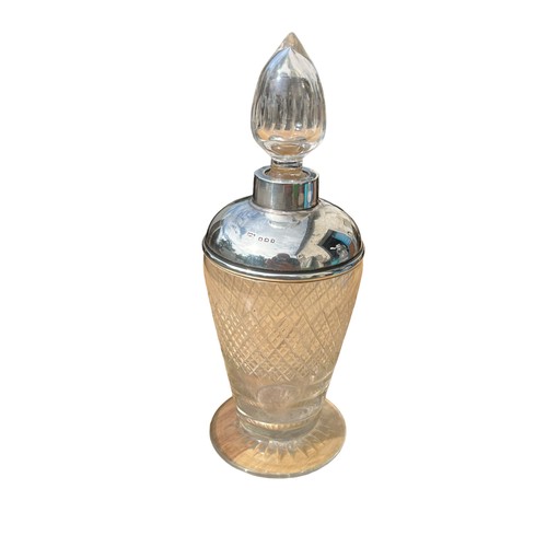 486 - A SILVER TOPPED PERFUME BOTTLE WITH STOPPER **