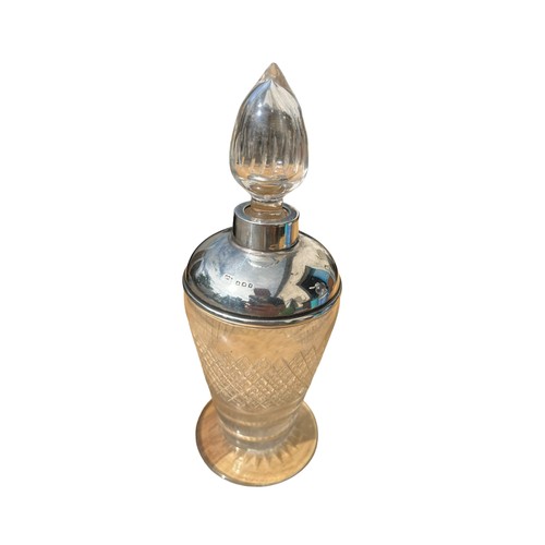 486 - A SILVER TOPPED PERFUME BOTTLE WITH STOPPER **