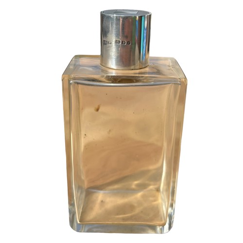 524 - A RECTANGULAR SILVER TOPPED BOTTLE