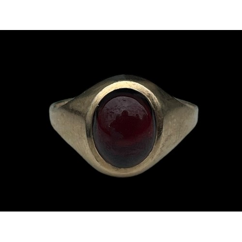 557 - A 9ct GOLD CUBION GARNET RING