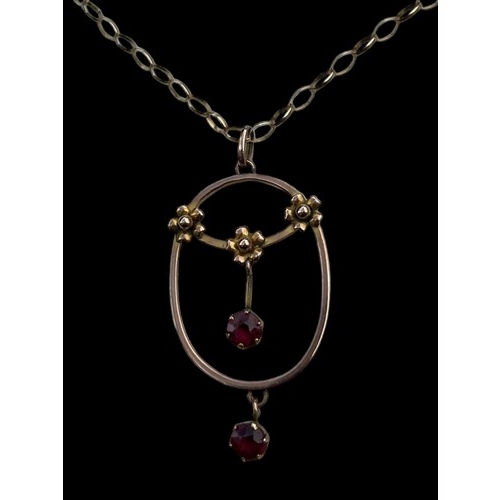 595 - A 9ct GOLD FLORAL PENDANT SET WITH RUBIES ON A 9ct LOOP LINK CHAIN