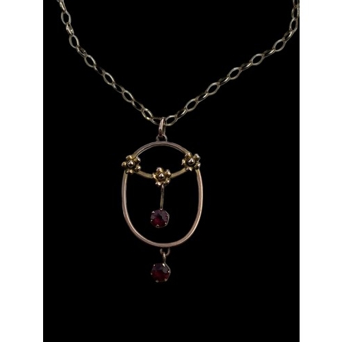 595 - A 9ct GOLD FLORAL PENDANT SET WITH RUBIES ON A 9ct LOOP LINK CHAIN