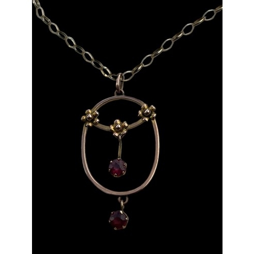 595 - A 9ct GOLD FLORAL PENDANT SET WITH RUBIES ON A 9ct LOOP LINK CHAIN