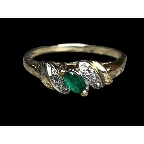 597 - A 14ct GOLD RING WITH EMERALDS AND DIAMOND CHIPS