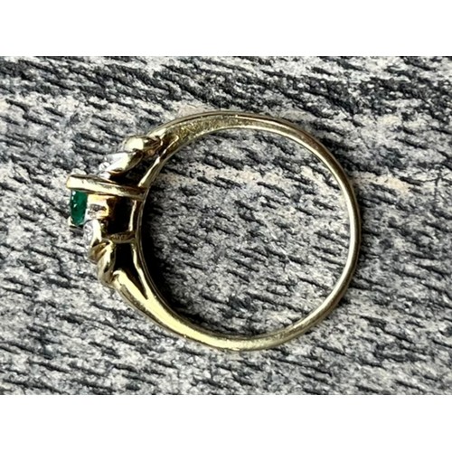 597 - A 14ct GOLD RING WITH EMERALDS AND DIAMOND CHIPS