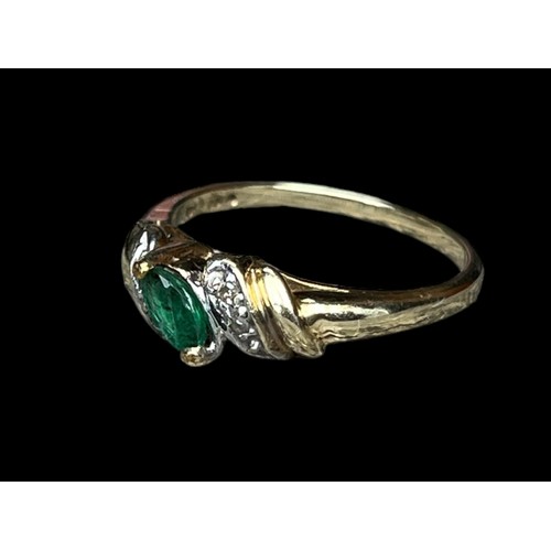 597 - A 14ct GOLD RING WITH EMERALDS AND DIAMOND CHIPS