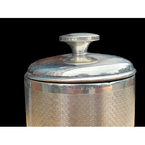 639 - AN ART DECO SILVER CIGARETTE JAR ENGINE TURNED PATTERN