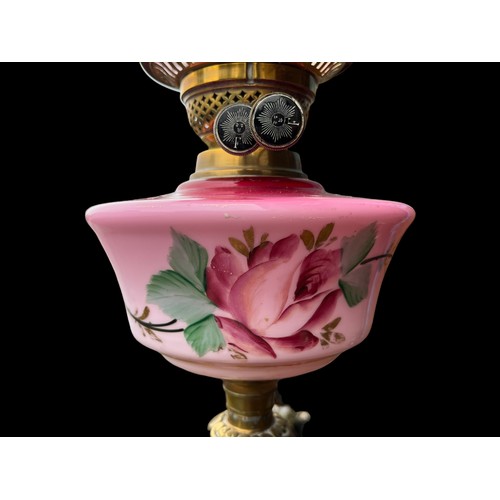 657 - A PINK PORCELAIN HAND PAINTED OIL LAMP BOWL WITH ORNATE BRASS BASE AND NICELY SHAPED SHADE