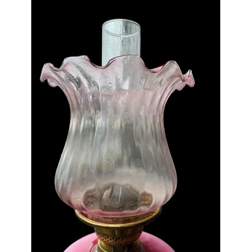 657 - A PINK PORCELAIN HAND PAINTED OIL LAMP BOWL WITH ORNATE BRASS BASE AND NICELY SHAPED SHADE