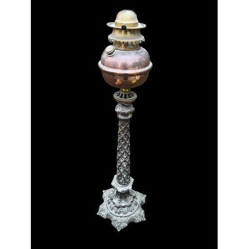 675 - A COPPER BOWL OIL LAMP ON A VERY ORNATE BRASS/BRONZE  BASE