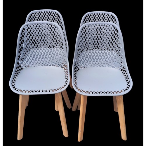 110 - A SET OF 4 MODERN OPENWORK BACKED CHAIRS ON BEECH FRAMES