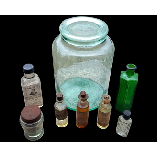 113 - A GLASS JAR AND LID FILLED WITH MINITURE CHEMIST BOTTLES