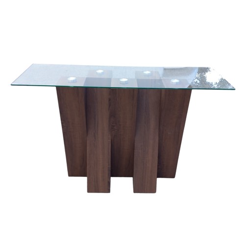 131 - A DESIGNER WALNUT CROSSED FRAMED CONSOL TABLE WITH A GLASS TOP