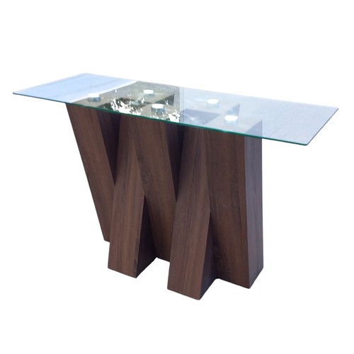 131 - A DESIGNER WALNUT CROSSED FRAMED CONSOL TABLE WITH A GLASS TOP