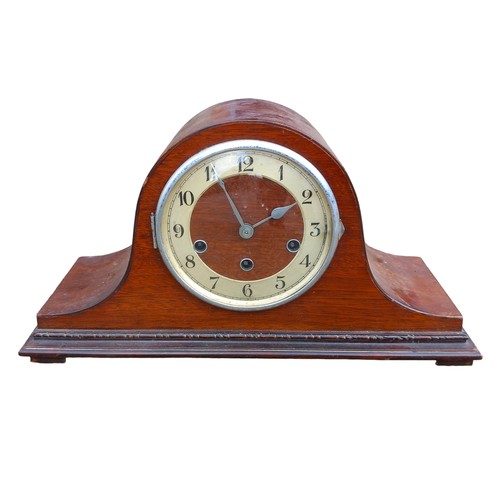 138 - A SHAPED MAHOGANY MANTLE CLOCK