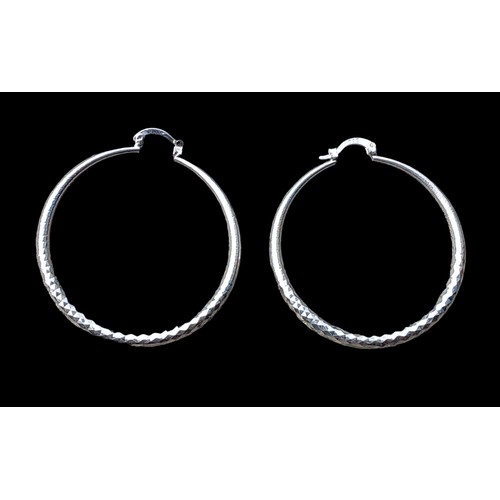 183 - A PAIR OF SILVER BRIGHT CUT HOOP EARRINGS