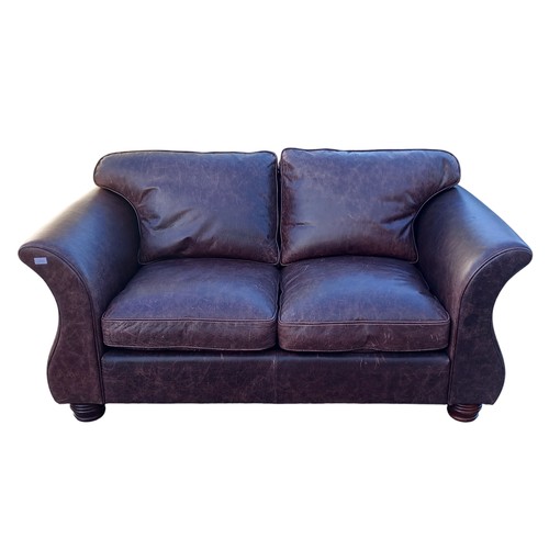 302 - A BROWN LEATHER 2 SEATER SETTEE