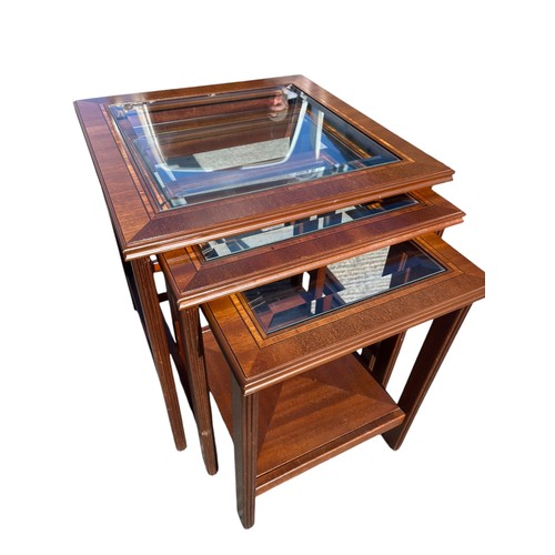 303 - A NEST OF 3 MAHOGANY TABLES WITH BEVELLED GLASS INSETS