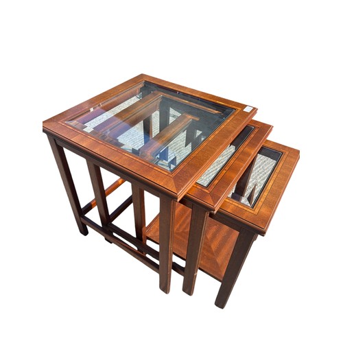 303 - A NEST OF 3 MAHOGANY TABLES WITH BEVELLED GLASS INSETS