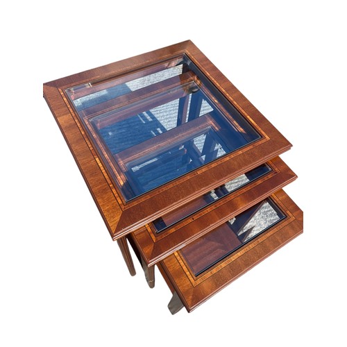 303 - A NEST OF 3 MAHOGANY TABLES WITH BEVELLED GLASS INSETS