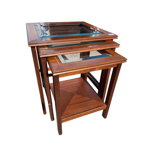 303 - A NEST OF 3 MAHOGANY TABLES WITH BEVELLED GLASS INSETS