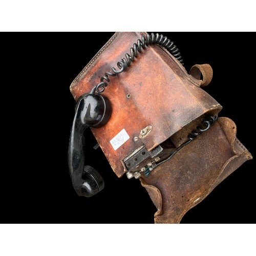 307 - A FIELD TELEPHONE IN ORIGINAL LEATHER CASE