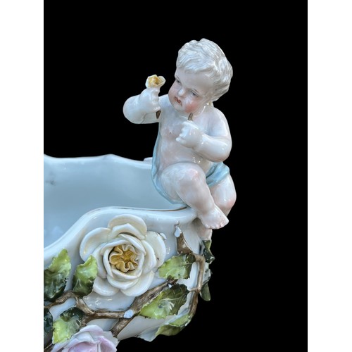 318 - A DECORATIVE 19c CENTRE PIECE WITH CHERUBS AND MARKINGS TO BASE