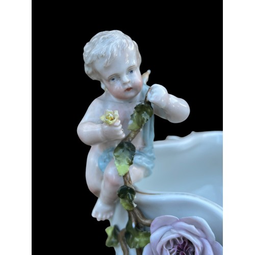 318 - A DECORATIVE 19c CENTRE PIECE WITH CHERUBS AND MARKINGS TO BASE