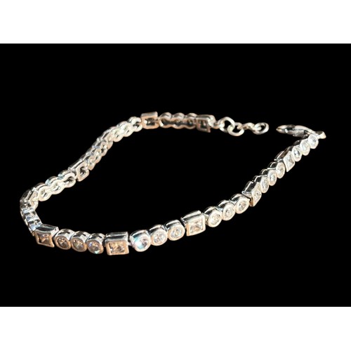 269 - A SILVER AND WHITE CRYSTAL LINE BRACELET WITH A TRIGGER CATCH