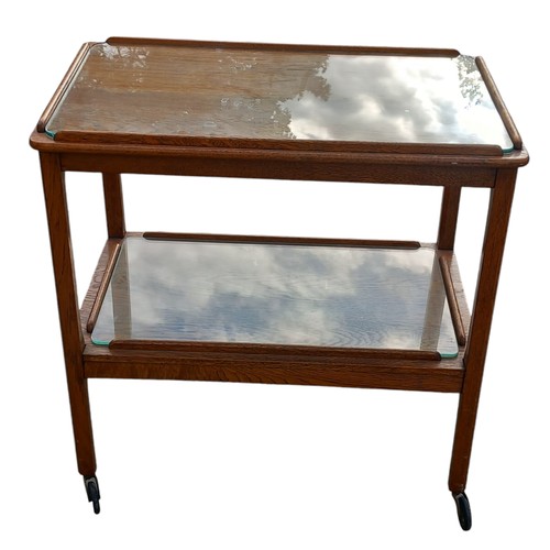 336 - A RETRO 2 TIER OAK TROLLEY WITH FITTED GLASS INSETS